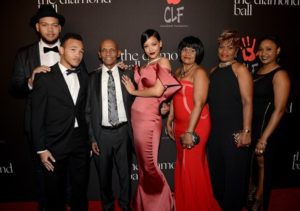 Rihanna and family pose on the red carpet (grandfather to her left) at the first annual Diamond Ball in Beverly Hills, California -- Direct Lyrics