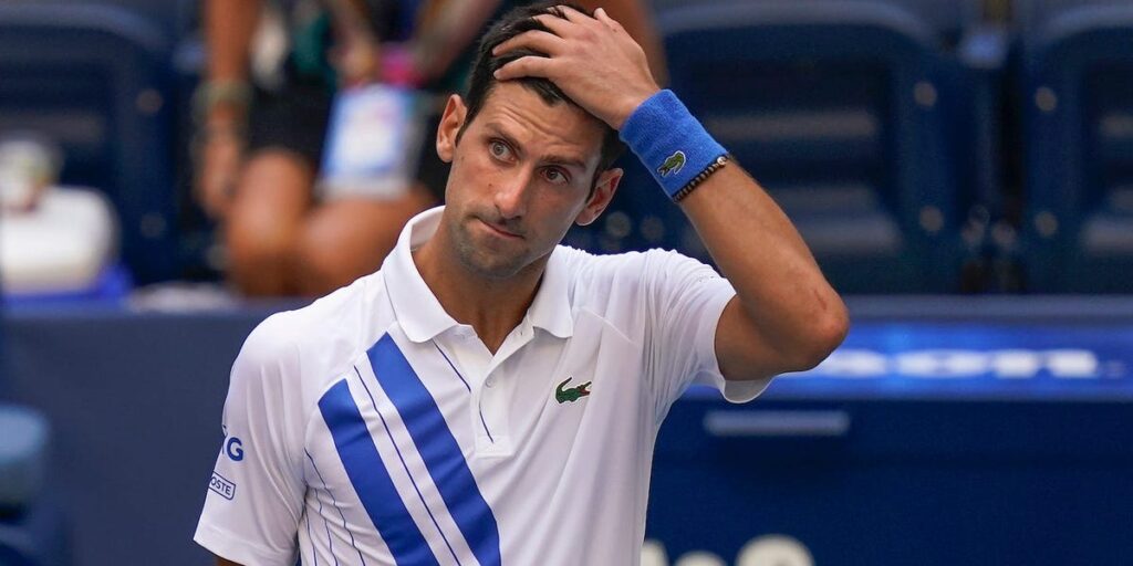 alt="Novak Djokovic shocked after default from US Open"