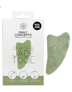 Photo of a Gua Sha, smooth green skincare tool, next to a box for the tool