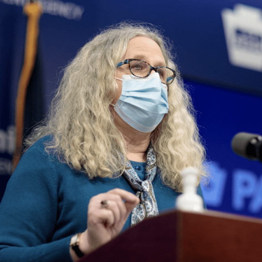 Photo of Rachel Levine wearing a mask speaking on a podium
