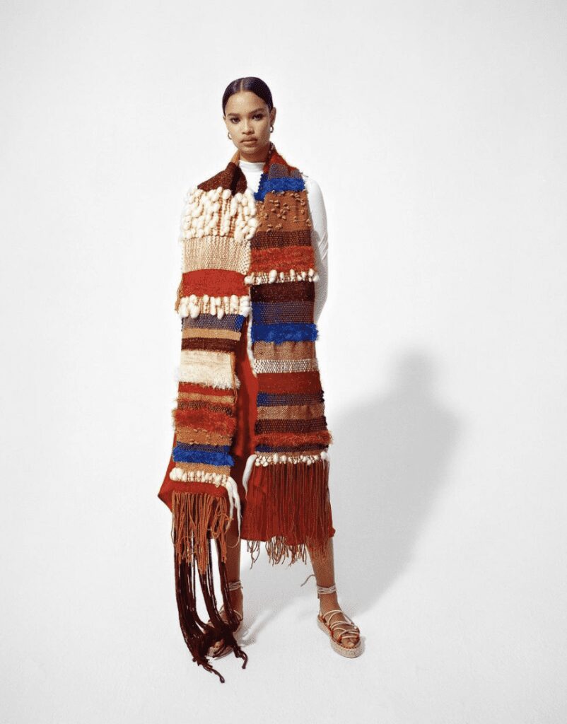 Photo of Coutts Collection piece with woman wearing textured tapestry around her