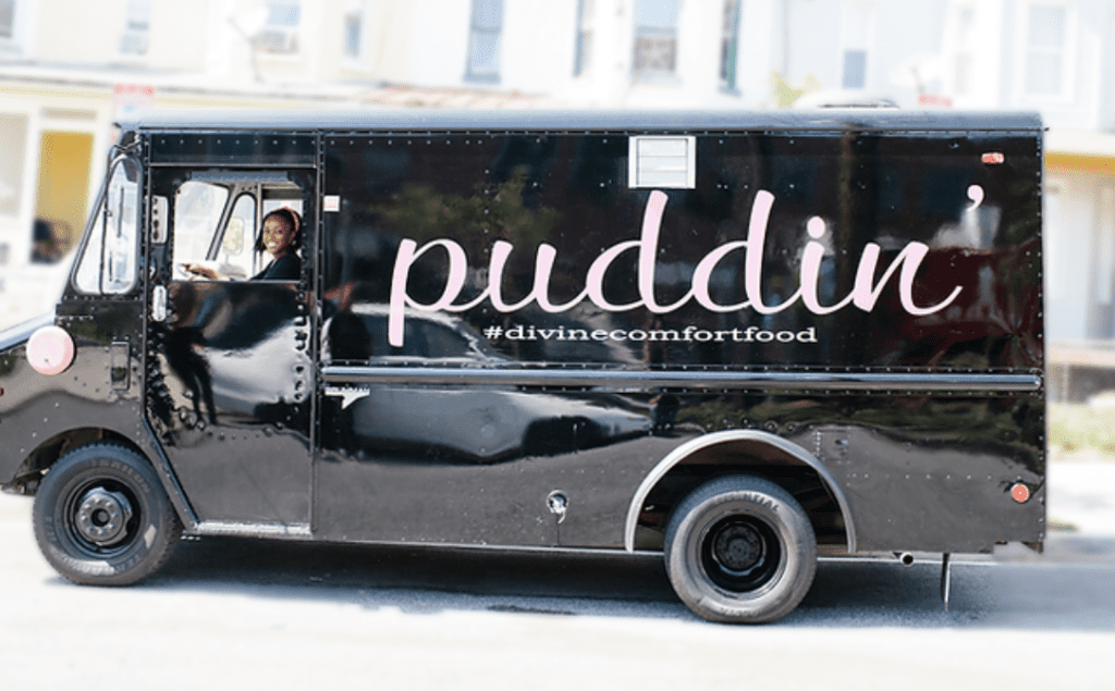 picture of owner of Puddin', Toyin Alli, in Puddin' truck.