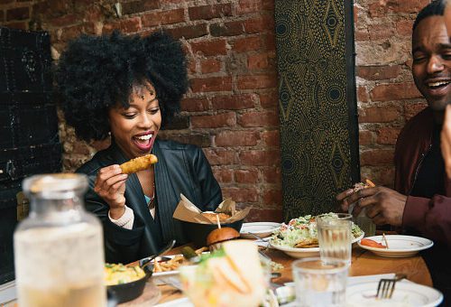 black woman eating food.