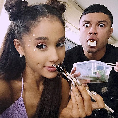Ariana Grande and male friend eating food.