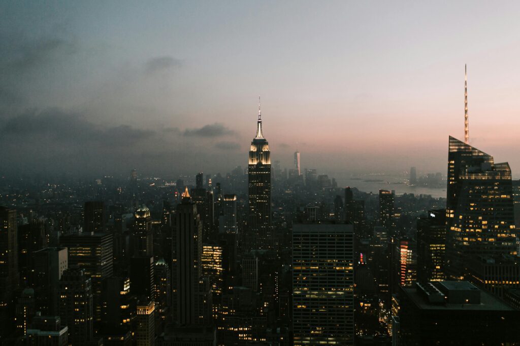 Skyline of New York City at sunset, the iconic backdrop of the Sex and the City reboot, symbolizing the show's return to its urban roots.