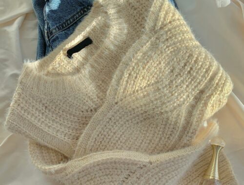 Cozy knit sweater paired with classic blue jeans showcasing casual timeless fashion.