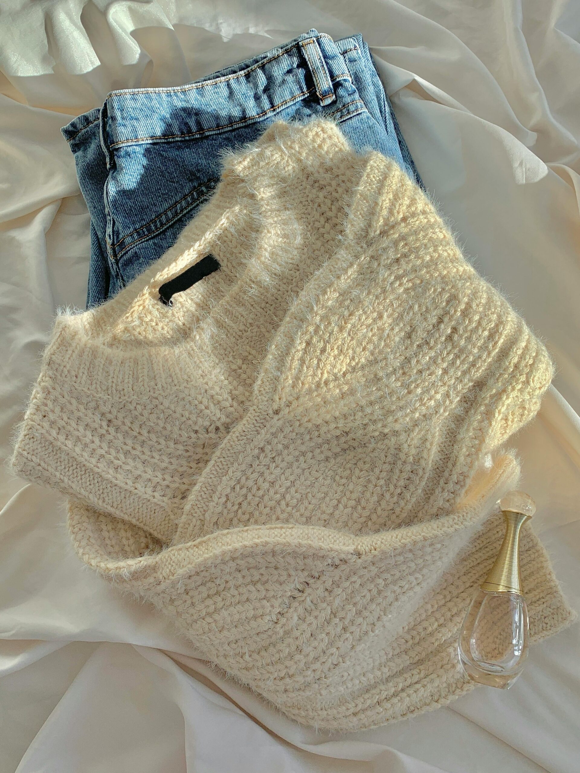 Cozy knit sweater paired with classic blue jeans showcasing casual timeless fashion.